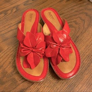 Born red leather sandal with floral accent.